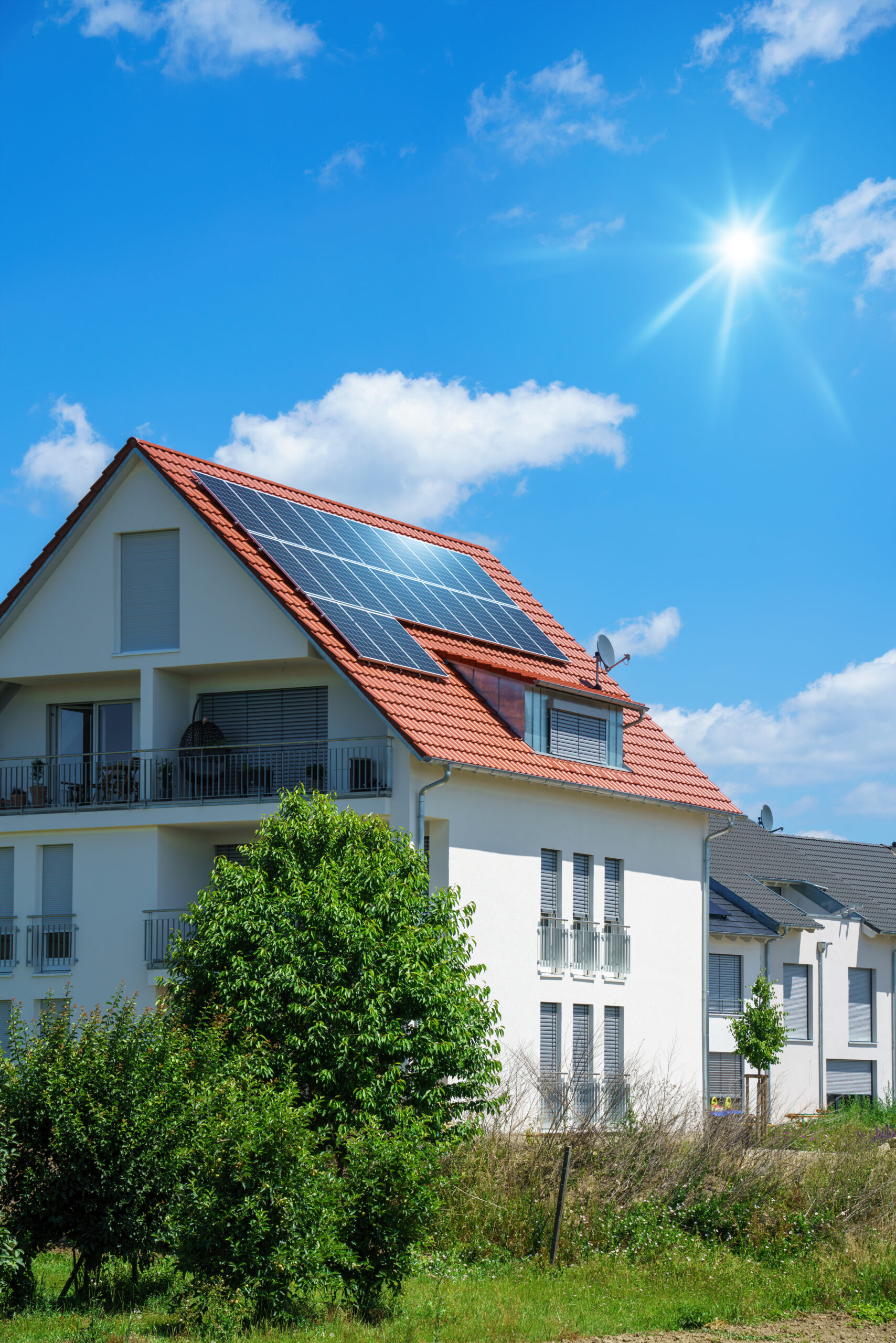 home with solar energy green plants and sunny blue sky